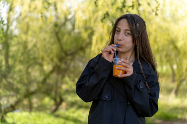 istock A girl drinking orange juice. 2151755388