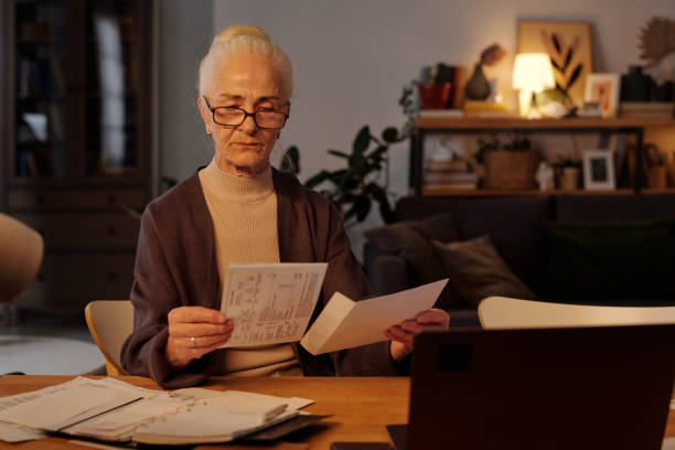 istock Taking financial bill out of envelope 2151756047