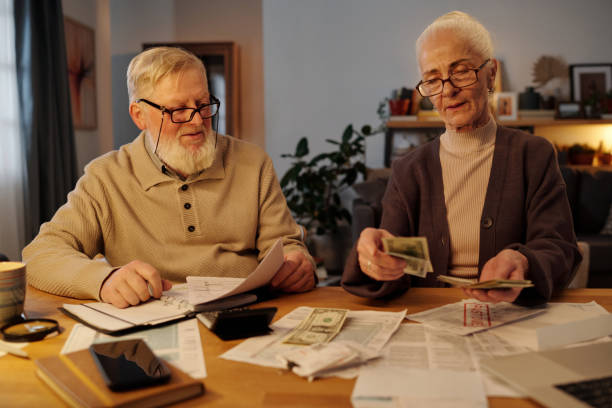 Man looking at his wife counting money