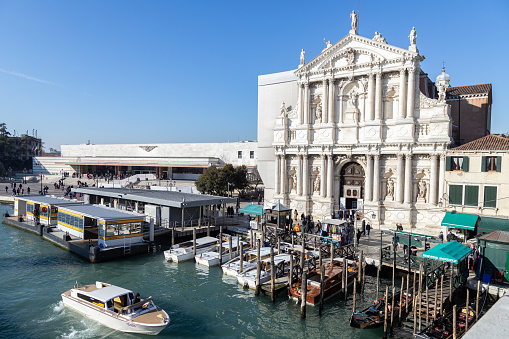 Venice, Veneto, Italy - Jan 23rd, 2024: View of Church of the Scalzi (Santa Maria di Nazareth), Train Station, Vaporetto Stop and Grand Canal on a beautiful sunny day in Venezia