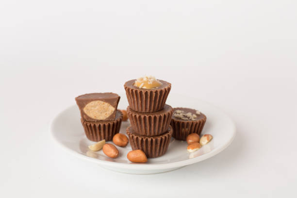 Tasty chocolate peanut butter cups on color background