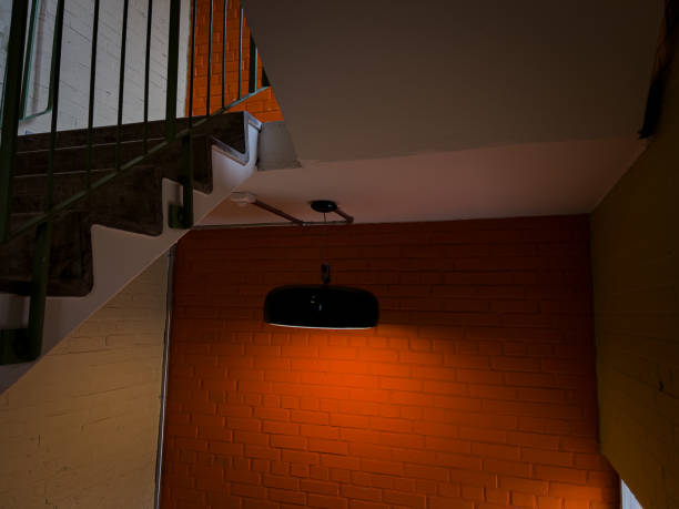 istock orange wall and green lamp hanging in an old building 2151766021