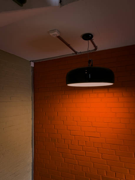 istock orange wall and green lamp hanging in an old building 2151766079