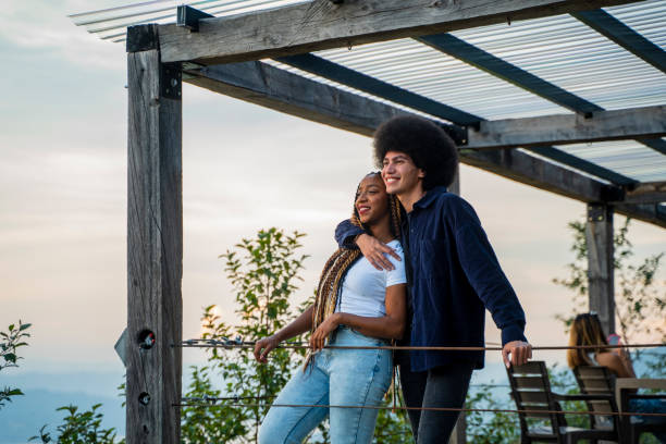 couple embracing looking at the landscape from the balcony