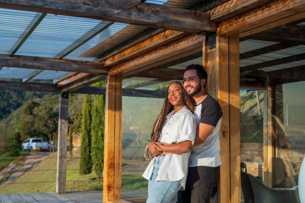 istock Couple in love looking through the window at the beautiful landscape 2151768607