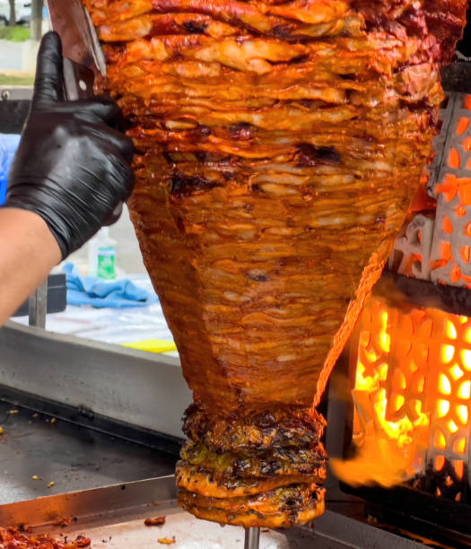 istock Cook preparing Tacos al Pastor in a mexican restaurant 2151769174