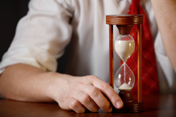 istock Businessman holding hourglass in his hand 2151770070