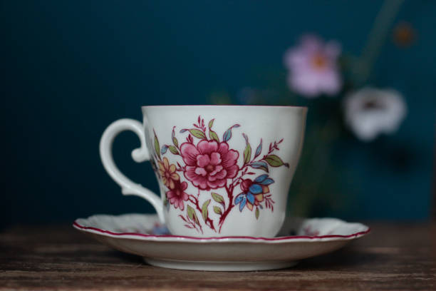 istock Vintage tea cup with flower print on wood surface 2151771274