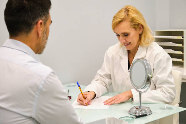 istock Aesthetic doctor woman writing patient personal data on a consent form. 2151771534