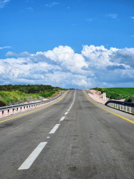 istock Asphalt road with blue sky and white clouds 2151774020