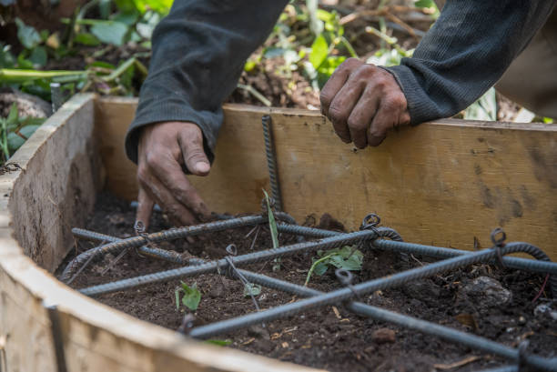 istock A man is working on a garden bed, laying down some wire mesh 2151775103