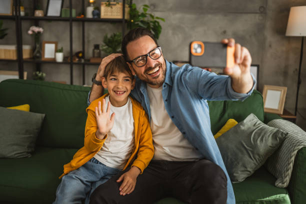 istock Father and son make a self portrait at living room 2151775748