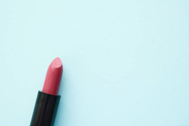 Pink lipstick on a blue background with space for text