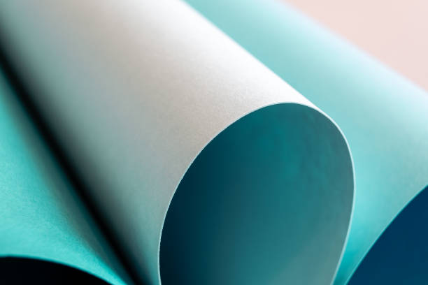 istock Curved cylinders of teal and white paper 2151776581