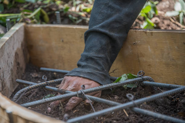 istock A man is digging in the dirt with a metal bar 2151776881