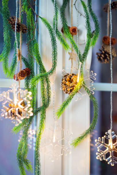istock Closeup of christmas decorations hanging on a window 2151780889