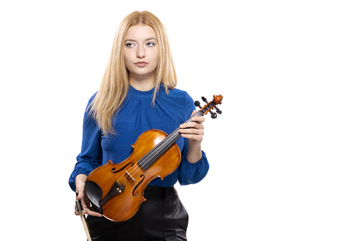 Elegant blond girl with a violin. Female violinist isolated on white background.