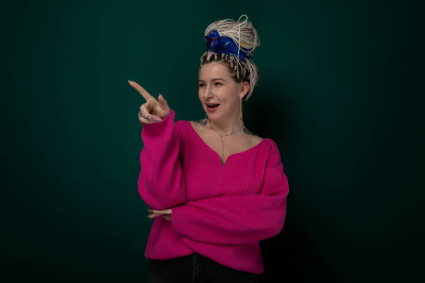 istock Woman in Pink Sweater Pointing at Camera 2151796804