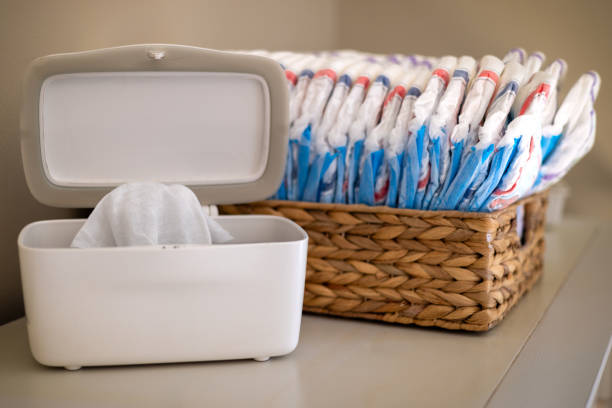 Diaper Wipes on Changing Table a diaper wipe bin open with a basket of diapers in the background Diaper stock pictures, royalty-free photos & images