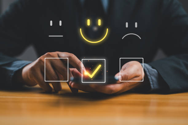 istock Businessman using smartphone for select smiley face icon for client evaluation and customer satisfaction after use product and service concept. 2151803453
