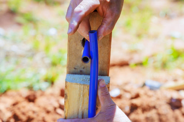 istock Using saw tools, a plumber makes cuts in blue PVC water piping 2151809512