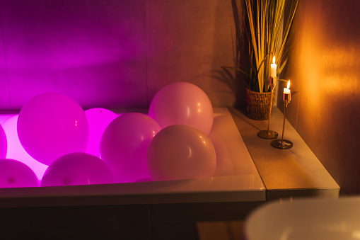 Gel balloons in  bathroom. Neon light