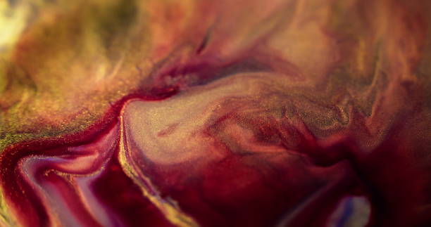 istock Paint flow glitter ink spill red purple golden mix 2151819601
