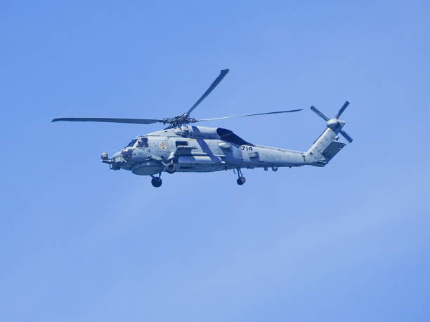Ho Chi Minh City, Vietnam - March 23, 2014: Exhibit item of the National War Museum. Close-up of American helicopter standing at forecourt with machine gun on warm sunny day