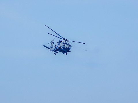 Two military helicopters flying.