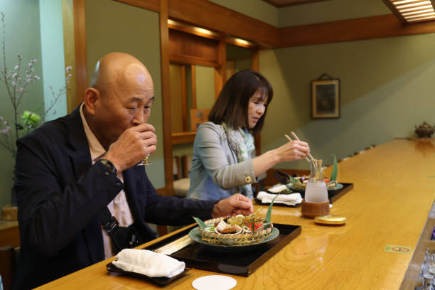 istock Midle age guests enjoying  luxurious dishes at high-class Japanese restaurant 2151822880