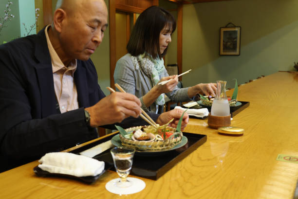 istock Midle age guests enjoying  luxurious dishes at high-class Japanese restaurant 2151823388
