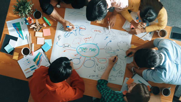 istock Group of business people writing and making mind map at meeting. Convocation. 2151830667
