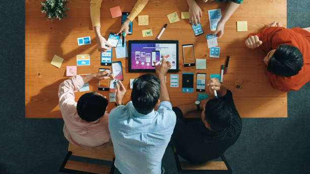 istock Top view of skilled business team writing idea on sticky note. Convocation. 2151831094