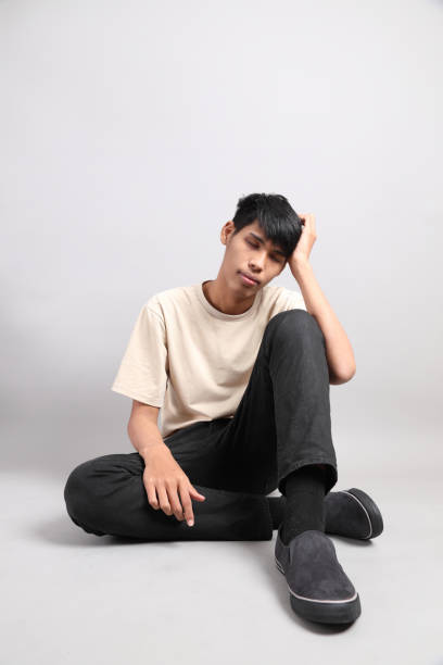 Happy laughing portrait young handsome southeast Asian man isolated on studio white background.