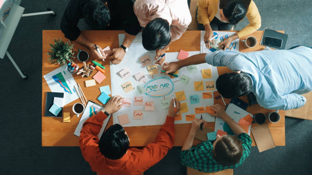istock Group of business people writing and making mind map at meeting. Convocation. 2151831445