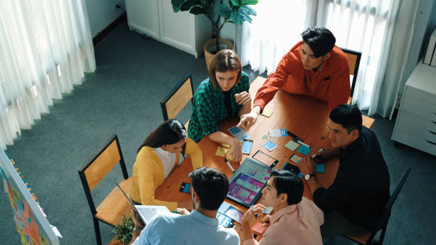 istock Top view of diverse people writing and stick sticky notes at board. Convocation. 2151832423