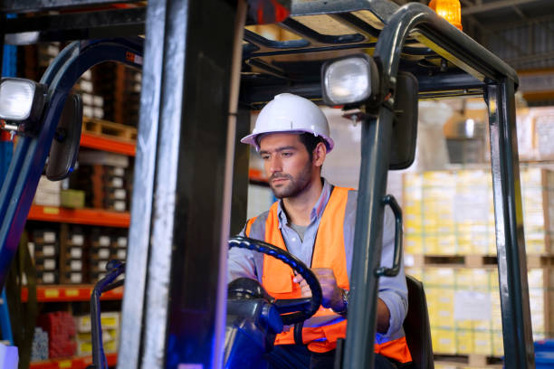 Blue collar worker is working at factory.