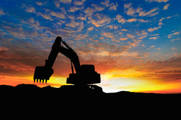 istock Crawler excavators silhouette are digging the soil in the construction site. 2151836057