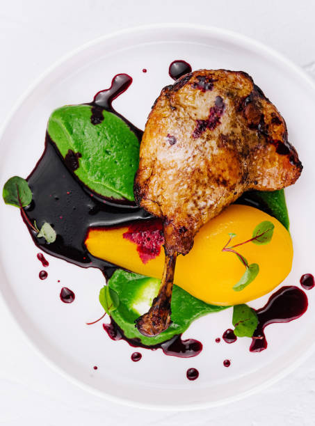 istock Gourmet chicken dish with colorful purees on white plate 2151836097
