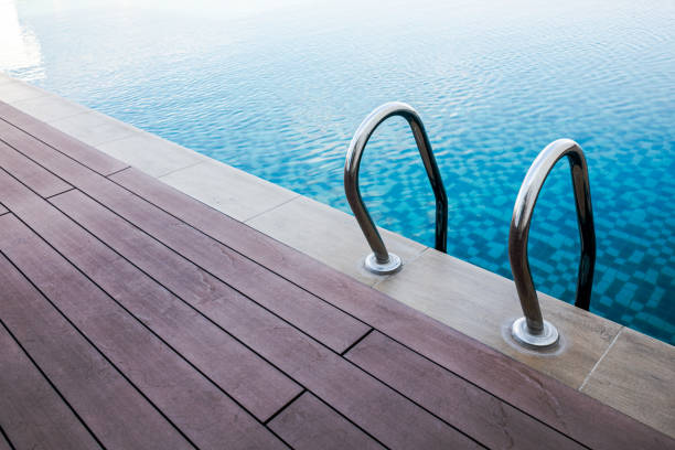 istock Swimming pool handrails and ladder. 2151836799