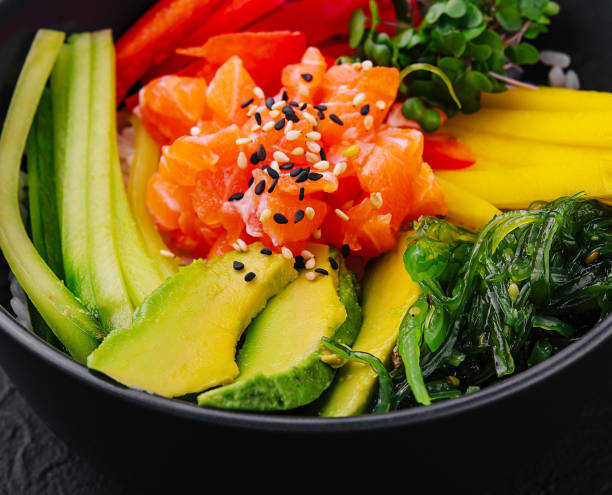 istock Fresh salmon poke bowl on dark background 2151836938
