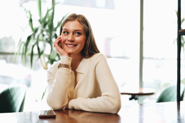 istock Woman Sitting at Table With Hand on Chin 2151837128