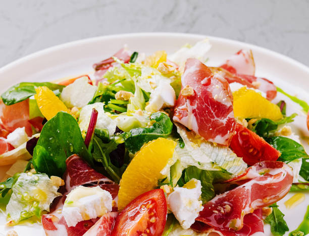 istock Fresh citrus and prosciutto salad on plate 2151837234