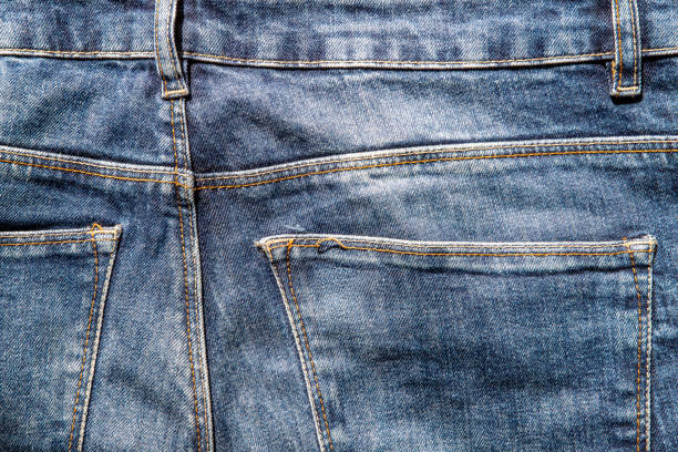 Close-Up Of Jeans Against White Background