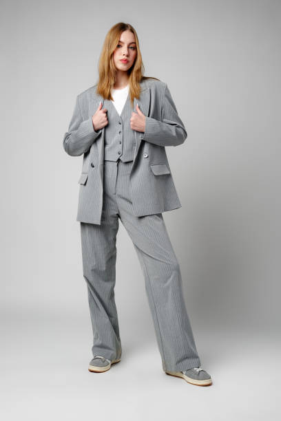 istock Woman in Gray Suit and White Shirt posing in studio 2151838267