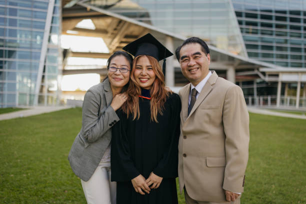istock Graduated daughter with proud parents 2151842286
