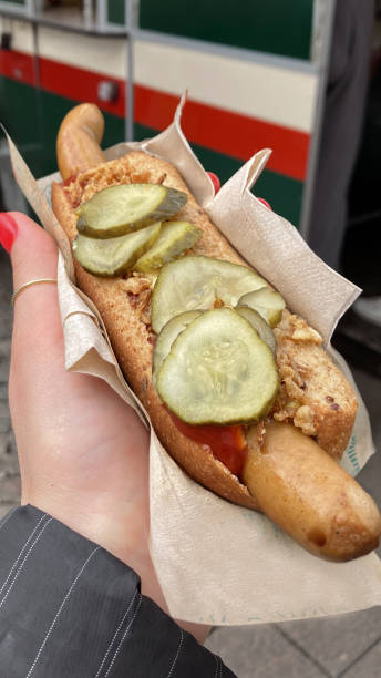 istock A Woman's Hand Holding a Fresh Hotdog 2151844548