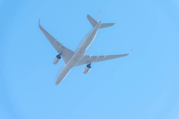 An Emirates Airbus A380-842 plane, registration A6-EVG, overhead at 17,000 feet after taking off from Sydney Kingsford-Smith Airport, circling around the city and heading southwest as flight EK412 to Christchurch. This image was taken from Kyeemagh Beach, Botany Bay on a sunny and cold morning on 26 May 2024.