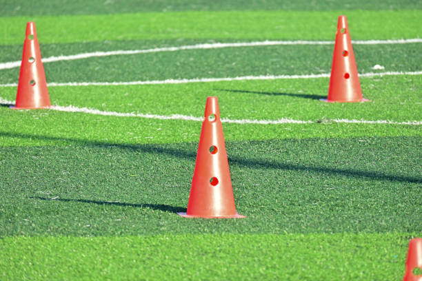 istock artificial green grass soccer field with orange training cones 2151847860