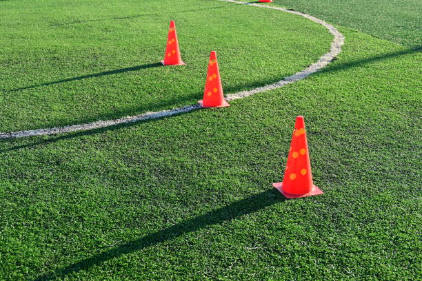 istock artificial green grass soccer field with orange training cones 2151848305
